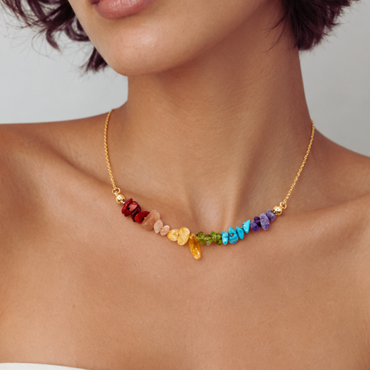 Necklace with colorful beads worn by a person on a neutral background
