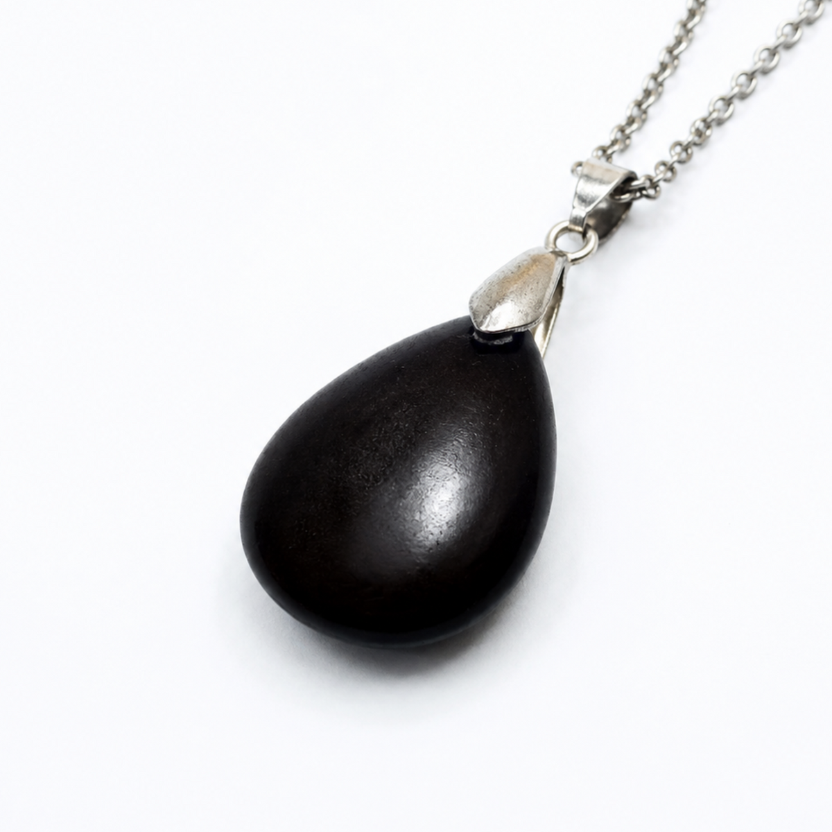 A teardrop-shaped black obsidian pendant necklace with a polished silver cap and a silver chain, shown on a plain white background.