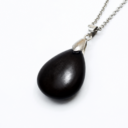 A teardrop-shaped black obsidian pendant necklace with a polished silver cap and a silver chain, shown on a plain white background.