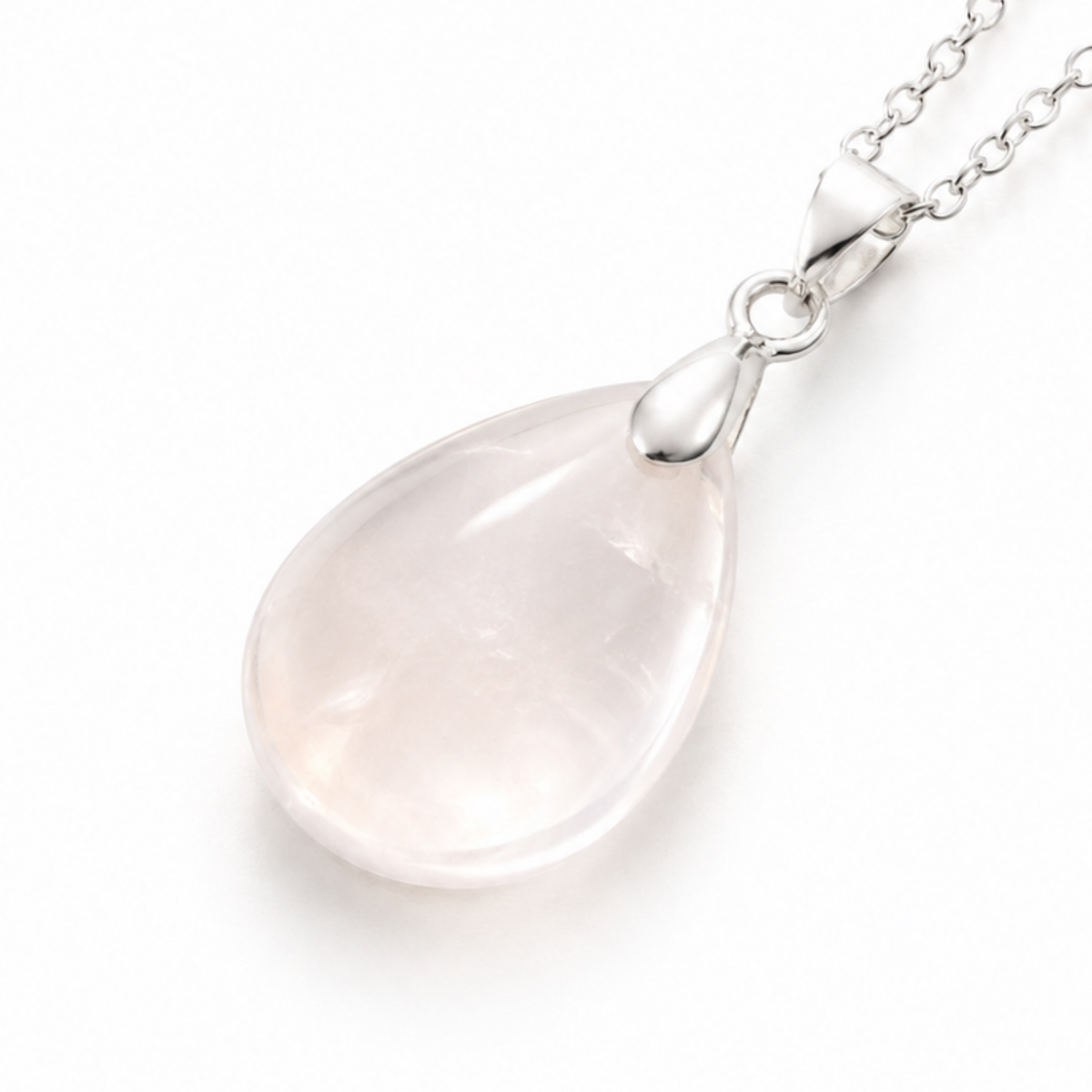 A teardrop-shaped rock quartz pendant necklace on a delicate silver chain, photographed against a clean white background.