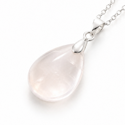 A teardrop-shaped rock quartz pendant necklace on a delicate silver chain, photographed against a clean white background.