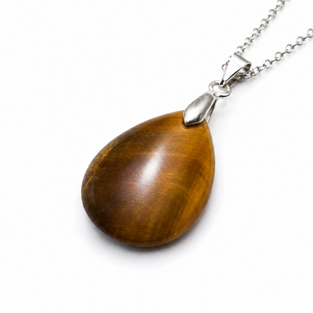 A teardrop-shaped pendant necklace made of polished tiger's eye stone with a silver bail and a silver chain, shown on a plain white background.